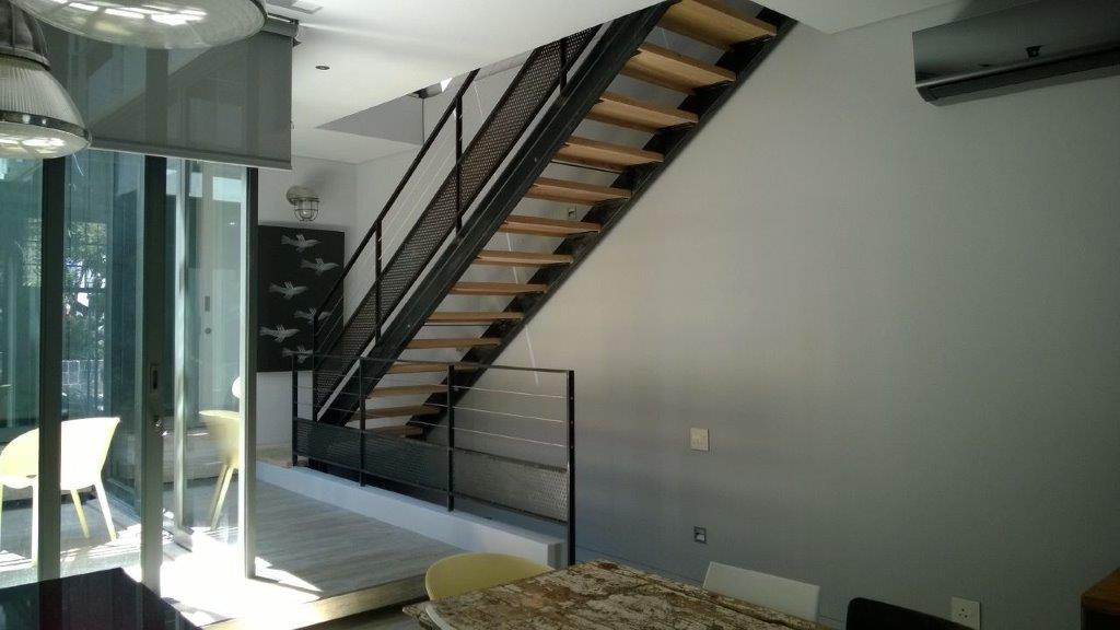 Mild steel staircase with wooden treads.